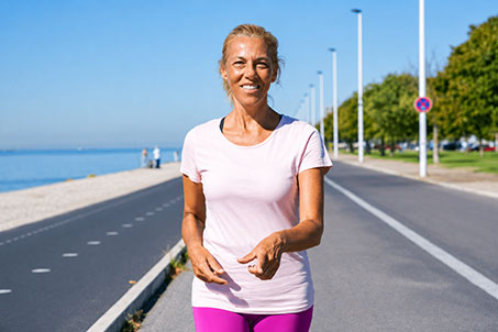 Active woman walking outdoors with improved appetite awareness and healthy lifestyle